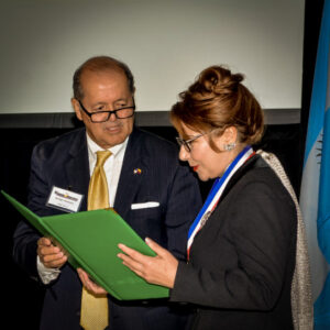 Mr. George Martinez presents Dr. Ocampo with a number of awards and honors at the 2016 National Hispanic Scientist of the Year awards in Tampa, FL.