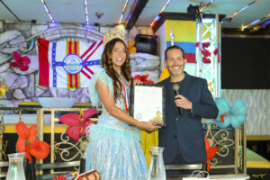 Tampa City Councilman Guido Maniscalco presents a commendation to Queen Natalia de Castro Gonzalez from Barranquilla, Colombia