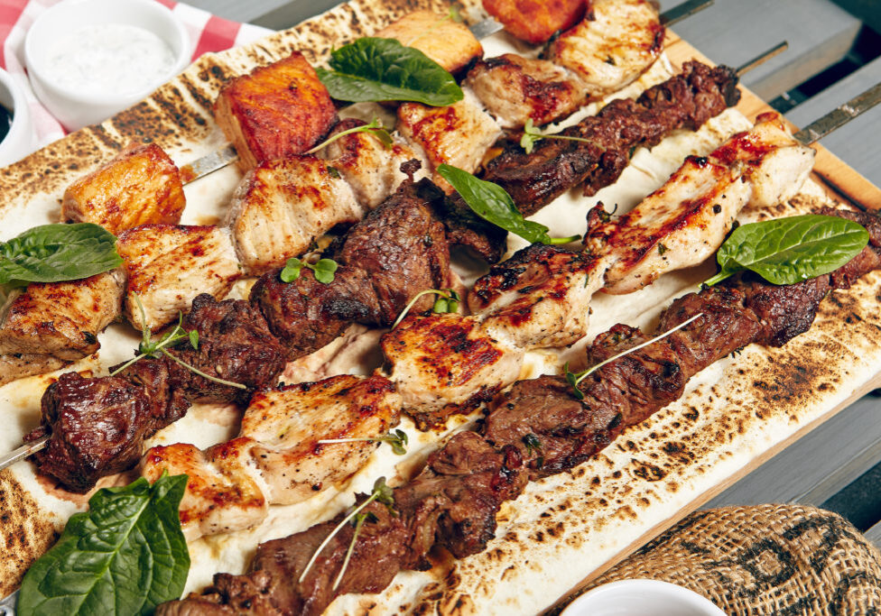 Chicken, Salmon and Meat Shish Kebabs on Parchment with Sauces